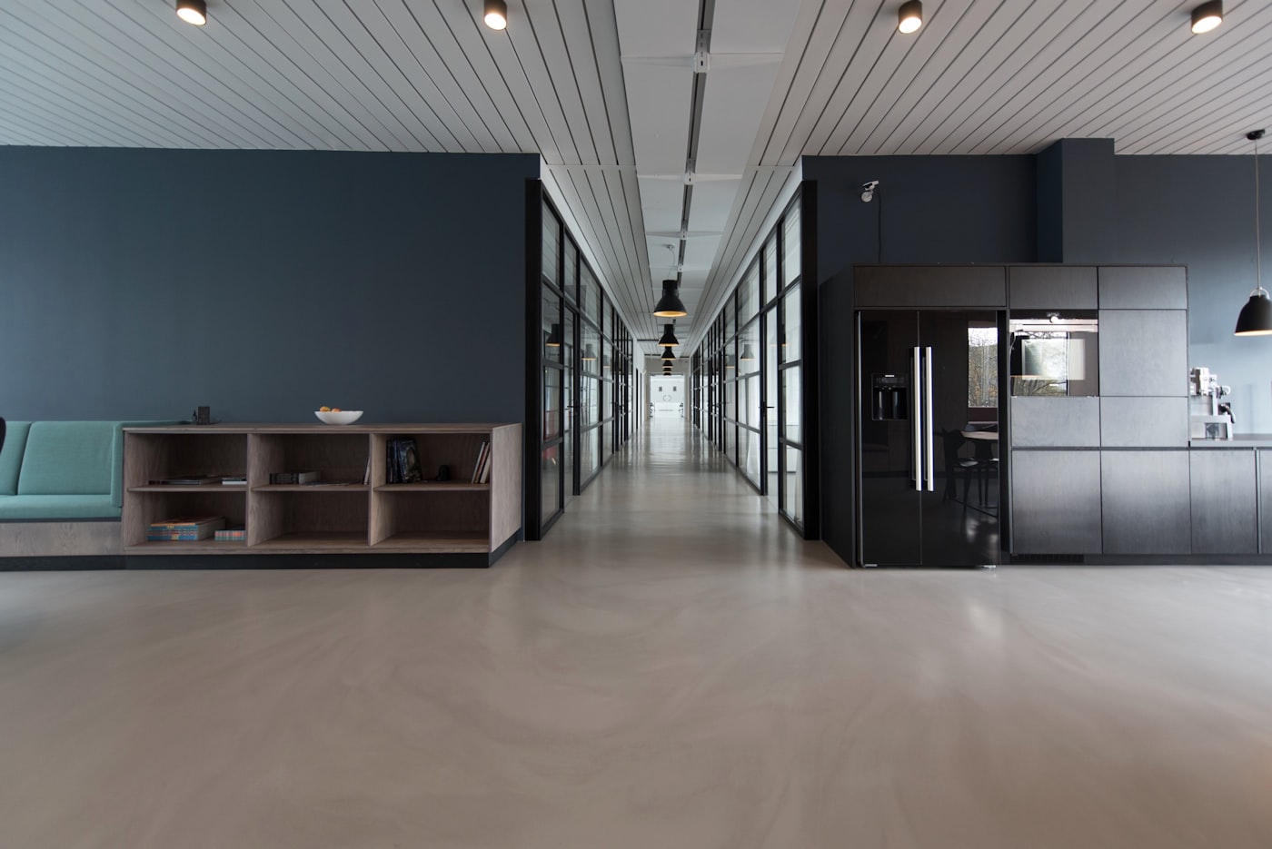 Quiet architectural corridor leading into a private training environment