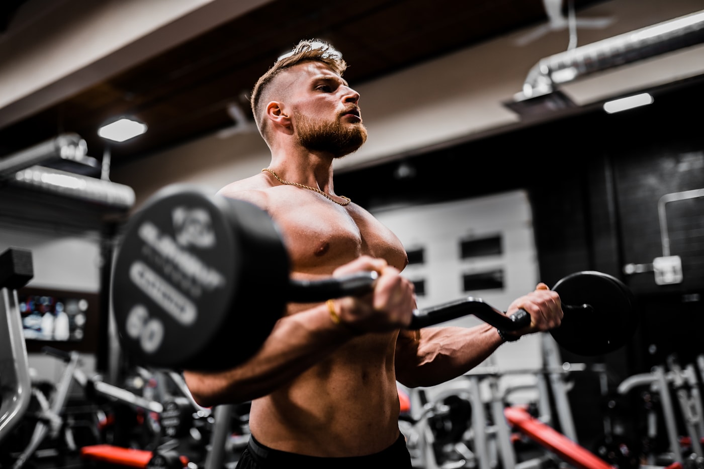 Focused strength training under architectural light in a dark private gym
